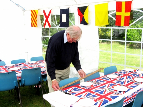 Peter Burman preparing tables for 2012 'Jubilee' Garden Party