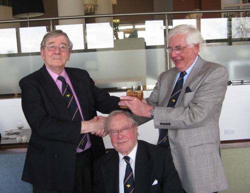 Graham Hall handing over the 'Gavel of Office' as Robin Ebsworth takes over as Chairman, April 2013. (Over Peter Burman's head)